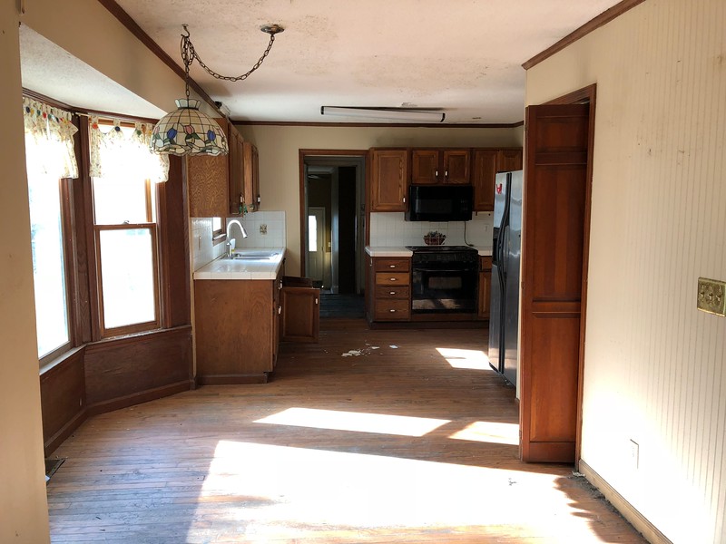 Family preparing for home renovation with packing boxes and planning at a rental house.