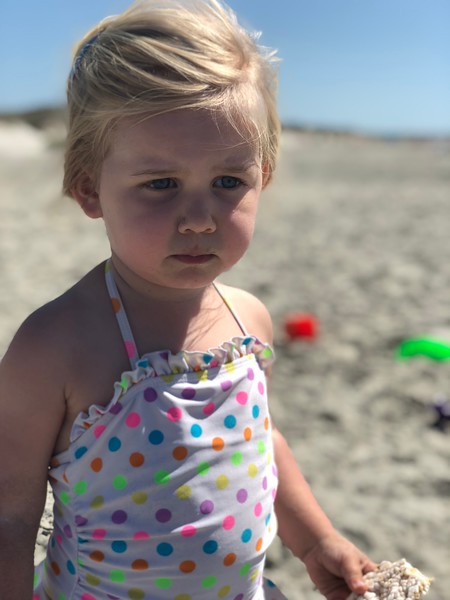 Family enjoying a summer backyard BBQ with outdoor dining and grill in Charleston.