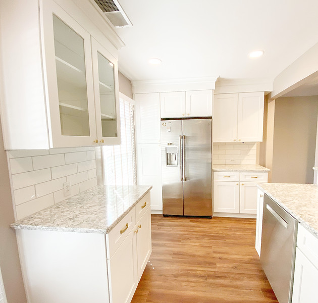 Before and after of a townhouse kitchen renovation showing modern cabinets, countertops, and fresh design updates.