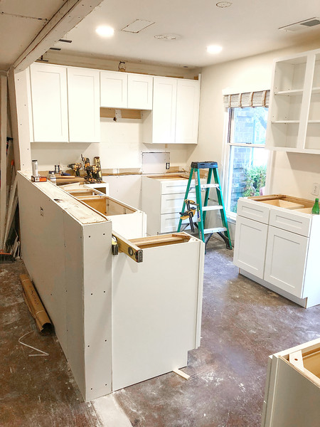 Before and after of a townhouse kitchen renovation showing modern cabinets, countertops, and fresh design updates.