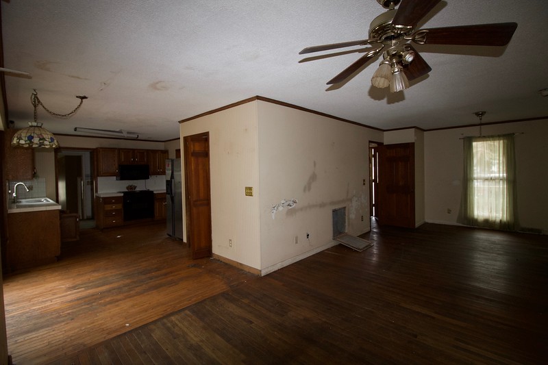 Before photos of a foreclosure home with a pool and spacious yard ready for renovation.