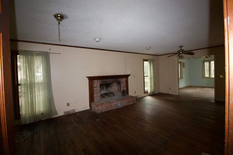 Before photos of a foreclosure home with a pool and spacious yard ready for renovation.