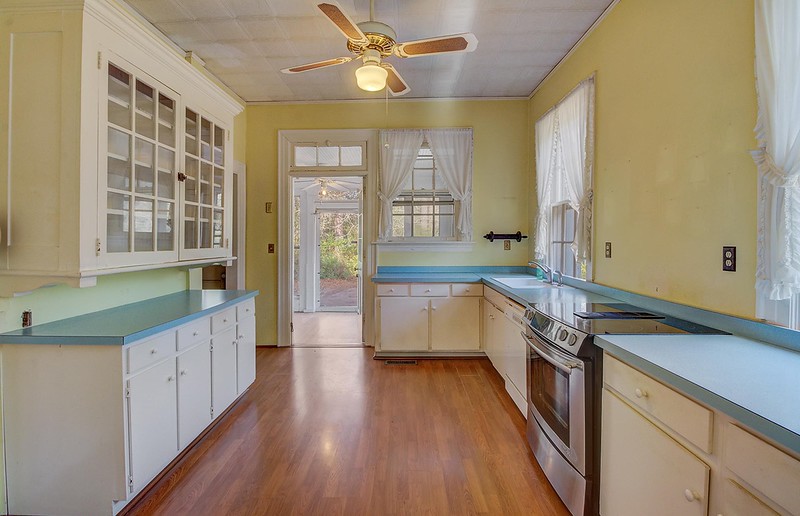 Historic 1930 Charleston home surrounded by trees on a private 2.5-acre lot.